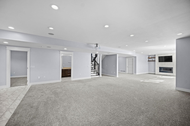 unfurnished living room featuring a large fireplace