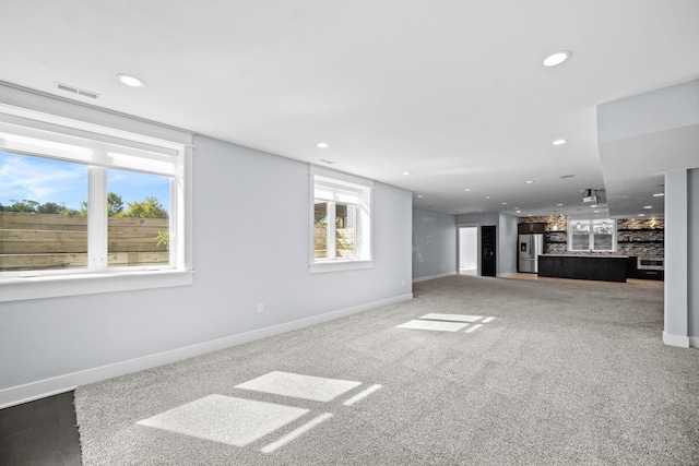 unfurnished living room featuring carpet flooring