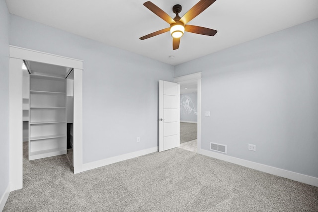 unfurnished bedroom featuring ceiling fan, a closet, and light colored carpet