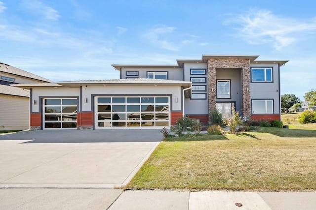 view of front of house with a front yard and a garage