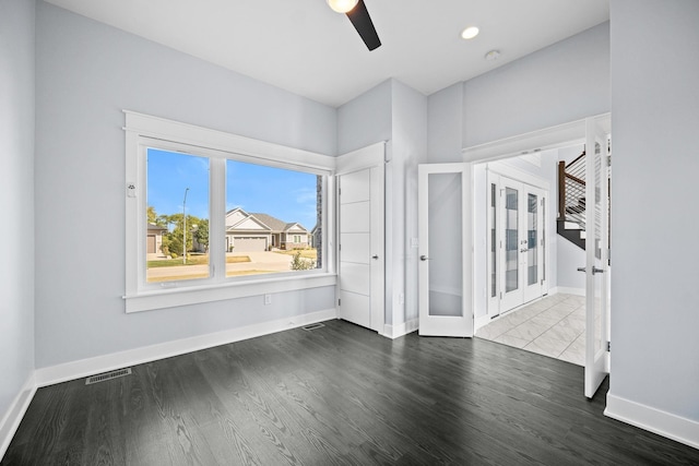 unfurnished room featuring ceiling fan, french doors, and hardwood / wood-style flooring