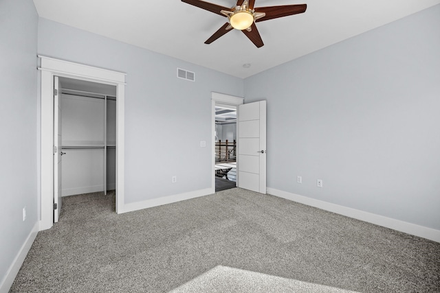 unfurnished bedroom with carpet, ceiling fan, and a closet