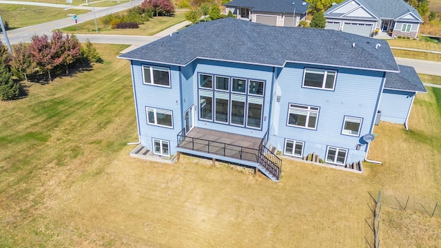 rear view of property featuring a yard