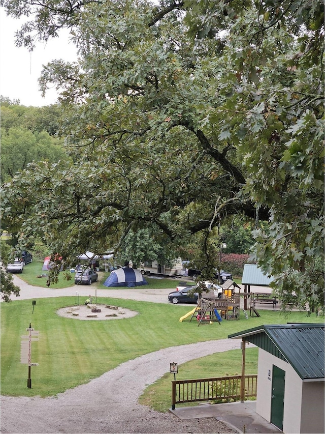 view of home's community featuring a yard and a playground