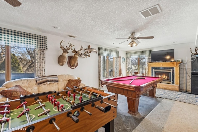 recreation room with ceiling fan, a textured ceiling, and pool table