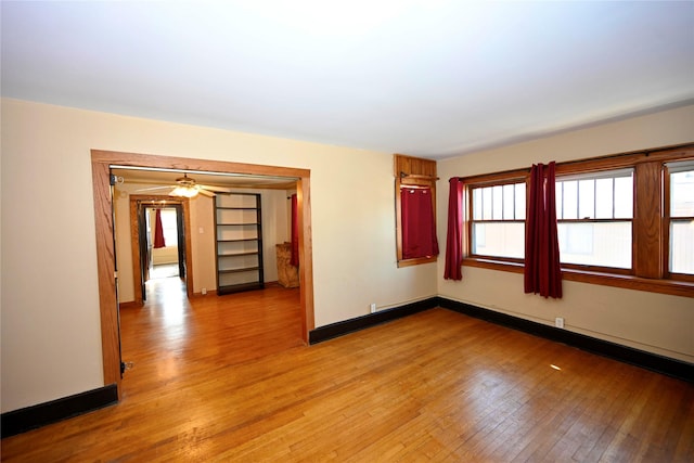 unfurnished room featuring light wood-type flooring, plenty of natural light, and ceiling fan