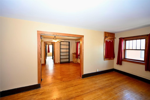 empty room featuring ceiling fan and light hardwood / wood-style floors