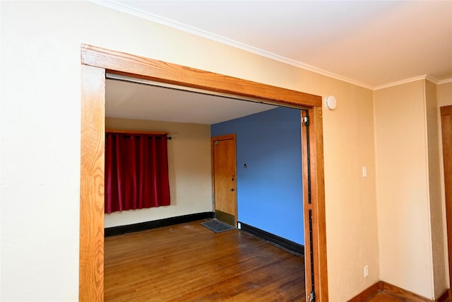 spare room featuring crown molding and dark hardwood / wood-style floors