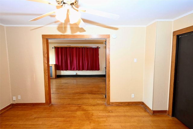 corridor featuring wood-type flooring and ornamental molding