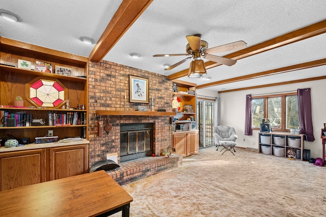 living room featuring a textured ceiling, carpet flooring, beamed ceiling, ceiling fan, and a fireplace