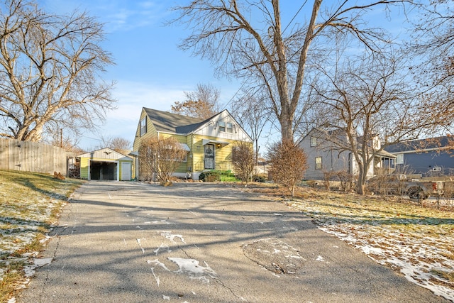 view of front of home with a garage and an outdoor structure