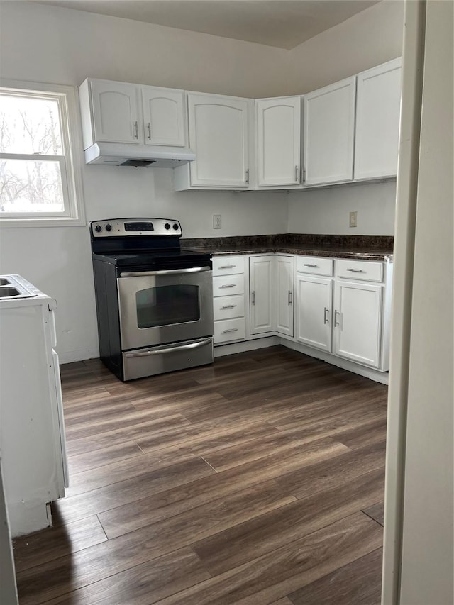 kitchen with electric range, white cabinets, and dark hardwood / wood-style floors