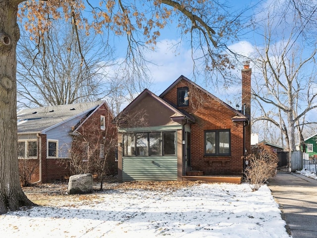 bungalow-style home with a sunroom