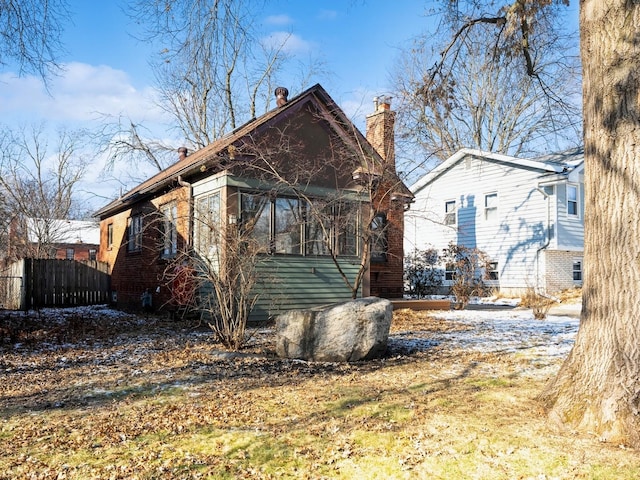 view of property exterior with a sunroom