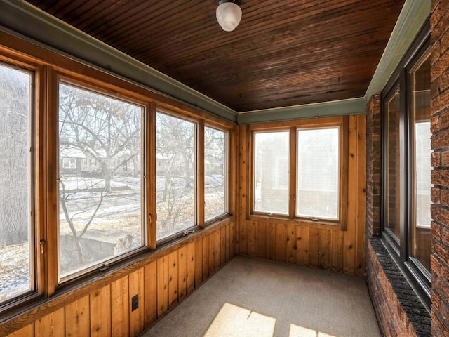 unfurnished sunroom with a healthy amount of sunlight and wood ceiling