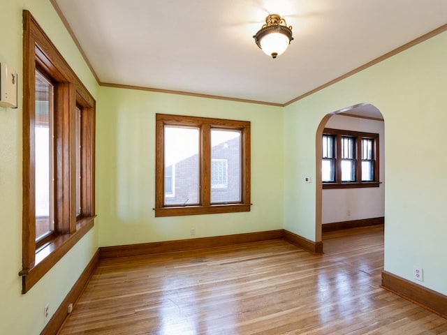 spare room with light hardwood / wood-style floors and ornamental molding