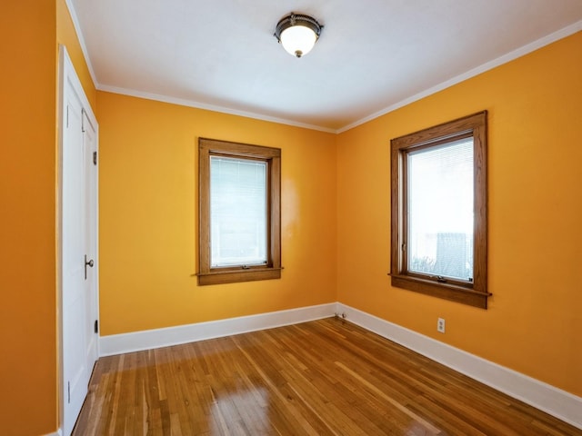 unfurnished room with wood-type flooring and crown molding