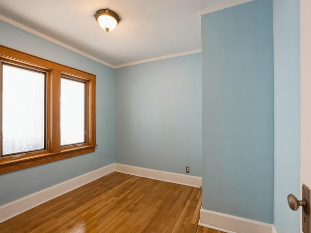 unfurnished room with hardwood / wood-style flooring and crown molding