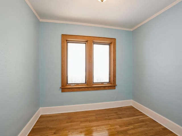 empty room with crown molding and hardwood / wood-style floors