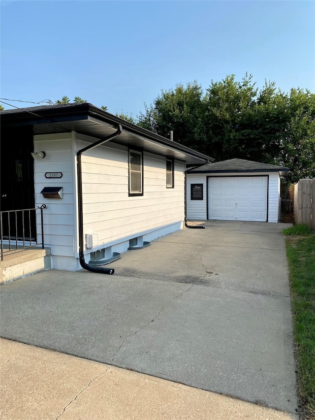 view of front of house with a garage and an outdoor structure