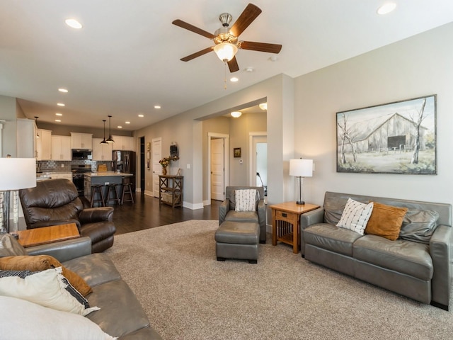 living room featuring ceiling fan and dark hardwood / wood-style floors