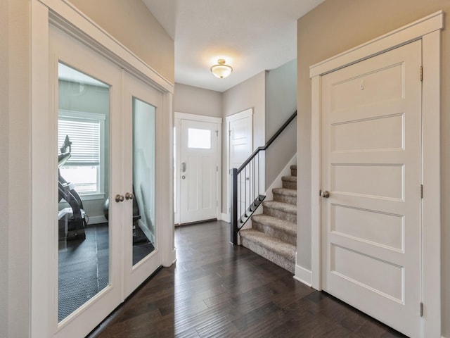 foyer entrance featuring french doors and dark wood-type flooring