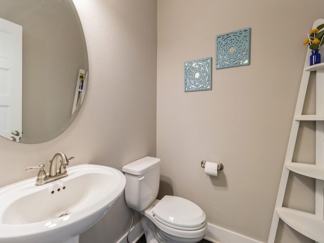 bathroom with toilet and sink