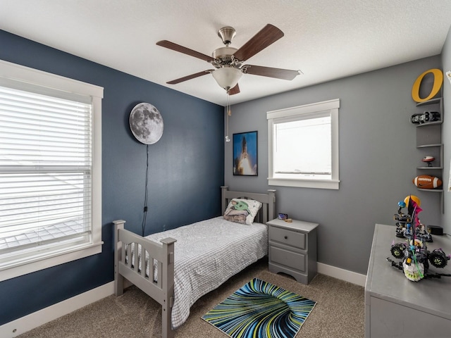 bedroom featuring ceiling fan and light carpet