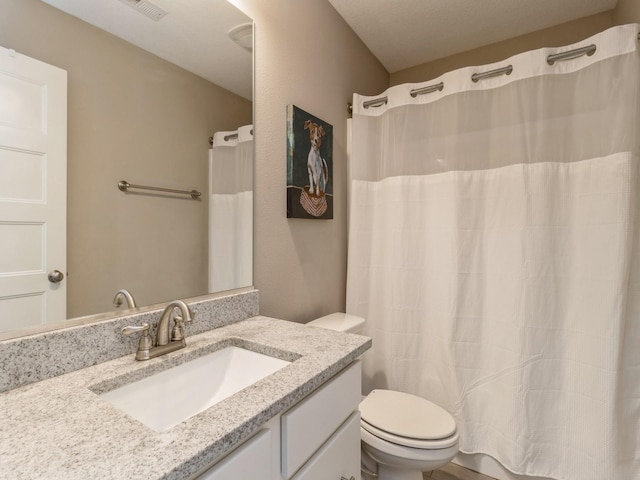 bathroom featuring vanity, a shower with shower curtain, and toilet