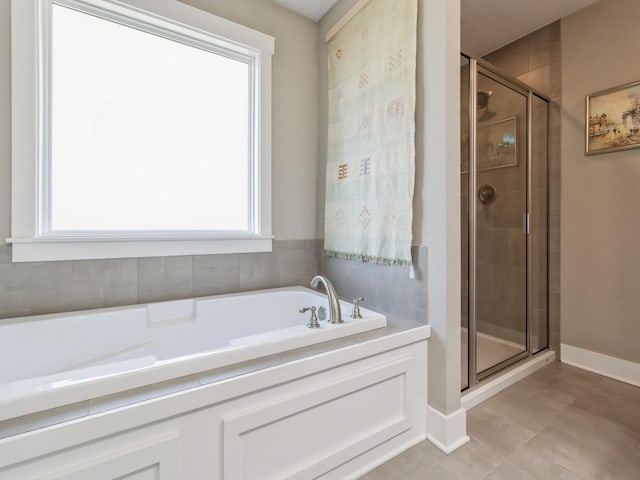 bathroom featuring plus walk in shower and a wealth of natural light