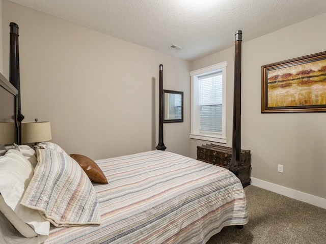 bedroom with carpet and a textured ceiling