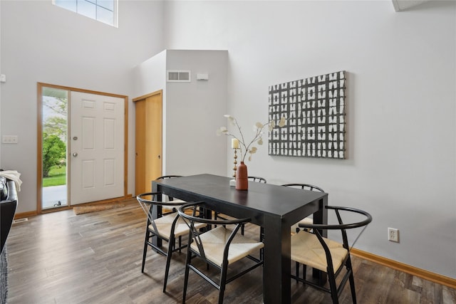 756 SE Williams Ct, Waukee, IA 50263 - dining room with healthy amount of natural light, wood finished floors, a high ceiling, and baseboards