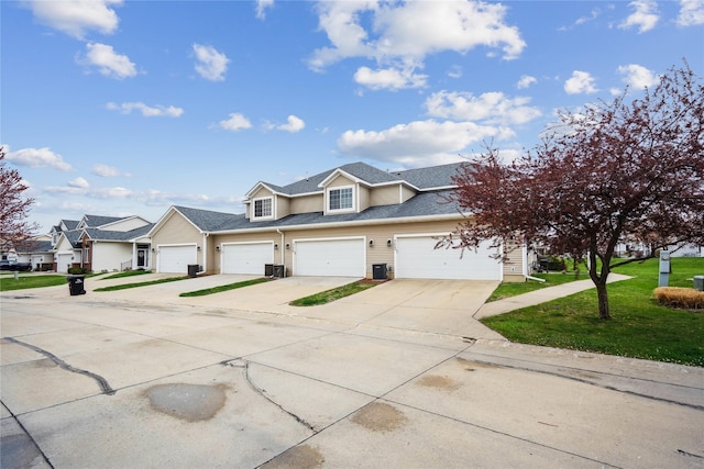 756 SE Williams Ct, Waukee, IA 50263 - townhome / multi-family property featuring concrete driveway, a front lawn, a residential view, roof with shingles, and cooling unit