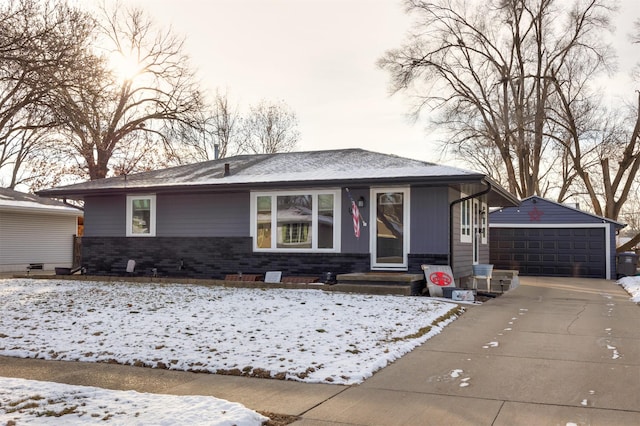 view of front of house featuring a garage and an outbuilding