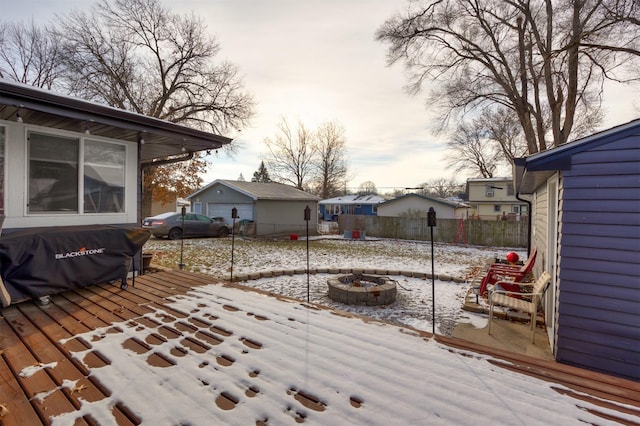 snow covered deck with an outdoor fire pit and grilling area