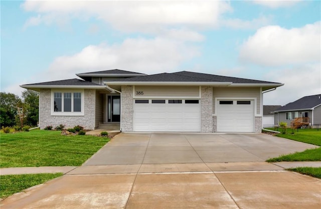 prairie-style home with a garage and a front yard