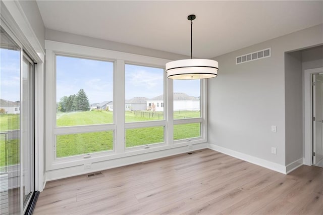 unfurnished dining area with light hardwood / wood-style floors