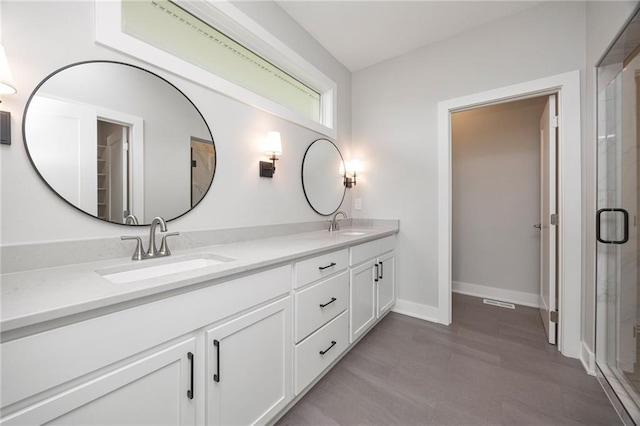 bathroom with vanity and an enclosed shower