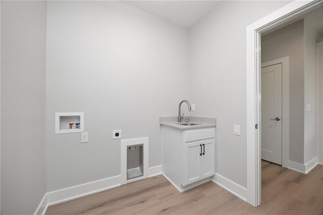 clothes washing area featuring light wood-type flooring, sink, hookup for a washing machine, and electric dryer hookup