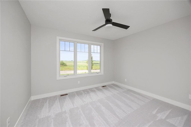 carpeted spare room with ceiling fan