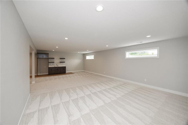 basement featuring light colored carpet