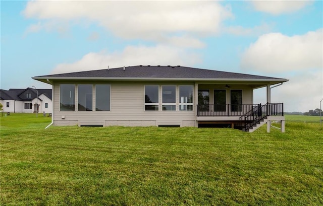 rear view of house with a yard