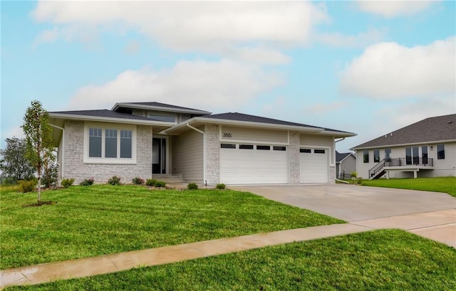 prairie-style house featuring a garage and a front lawn