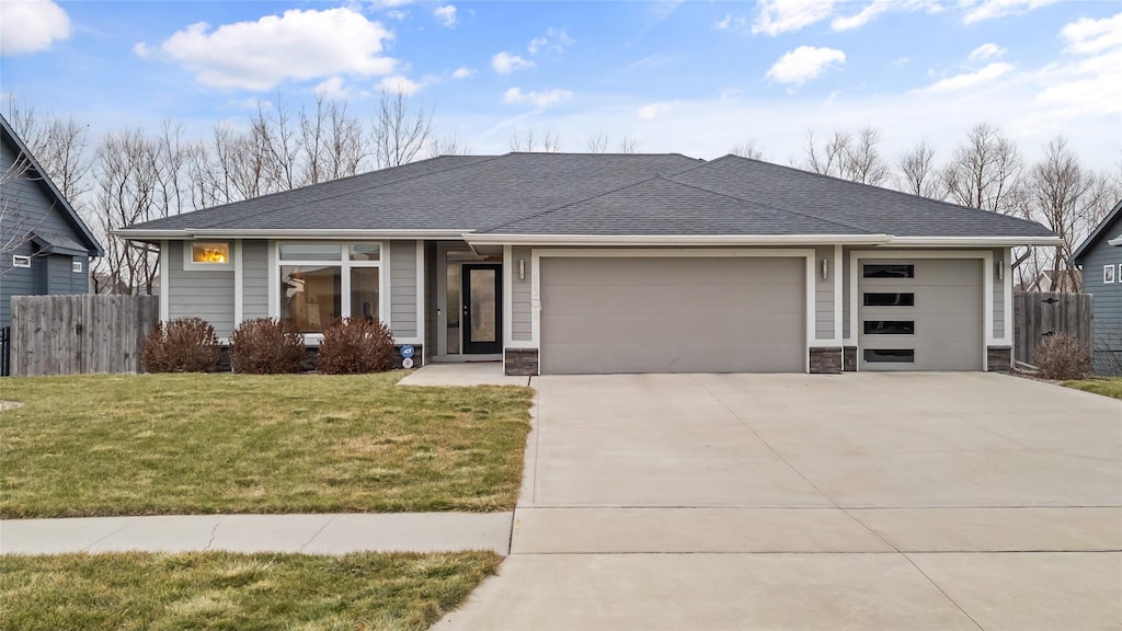 view of front of house featuring a garage and a front yard