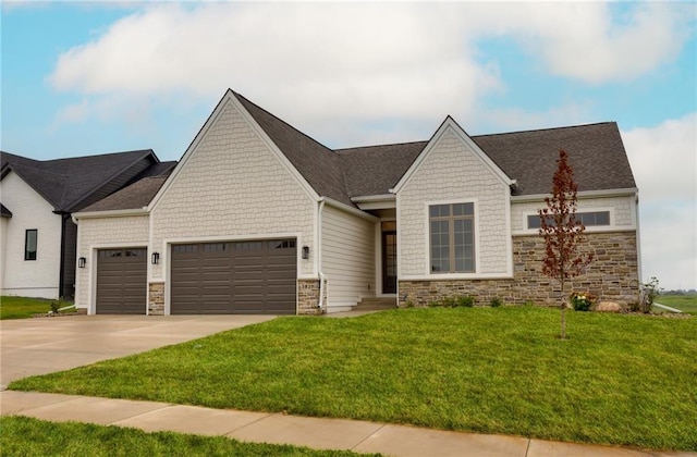 view of front of house with an attached garage, driveway, stone siding, and a front lawn