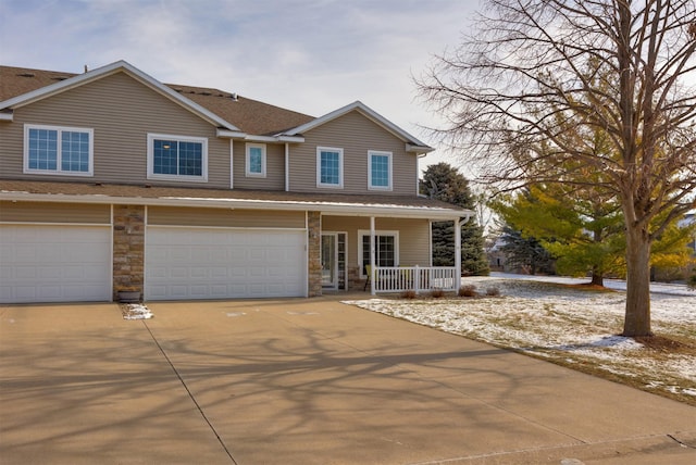 view of front of house featuring a porch and a garage