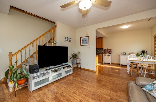 living room featuring ceiling fan and light wood-type flooring