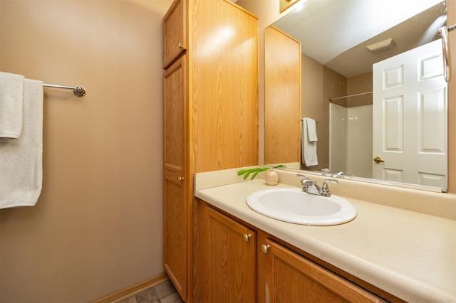 bathroom with vanity, tile patterned floors, and a shower