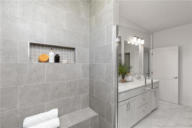 bathroom with vanity and lofted ceiling