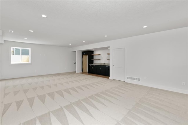 unfurnished living room with light carpet